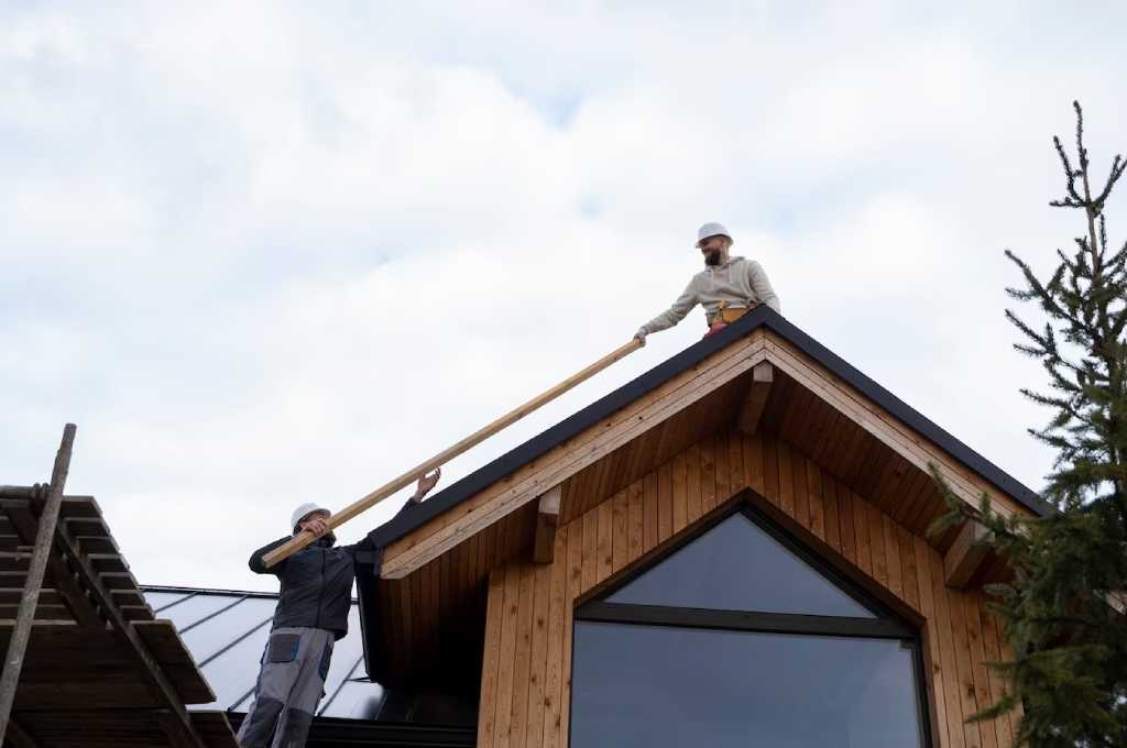 Two professional roofers working together in installing new roof