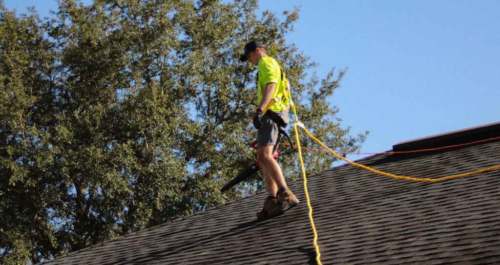 Man standing on the roof for roof repair
