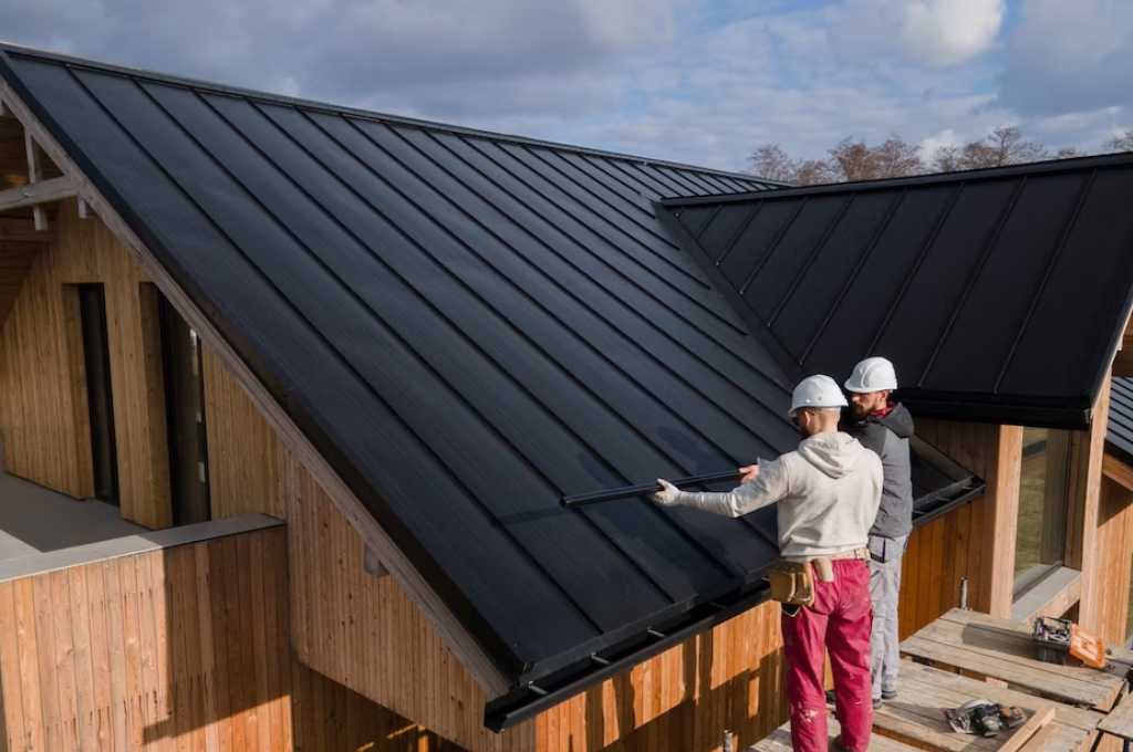 Two professional roofer communicating on a roof project