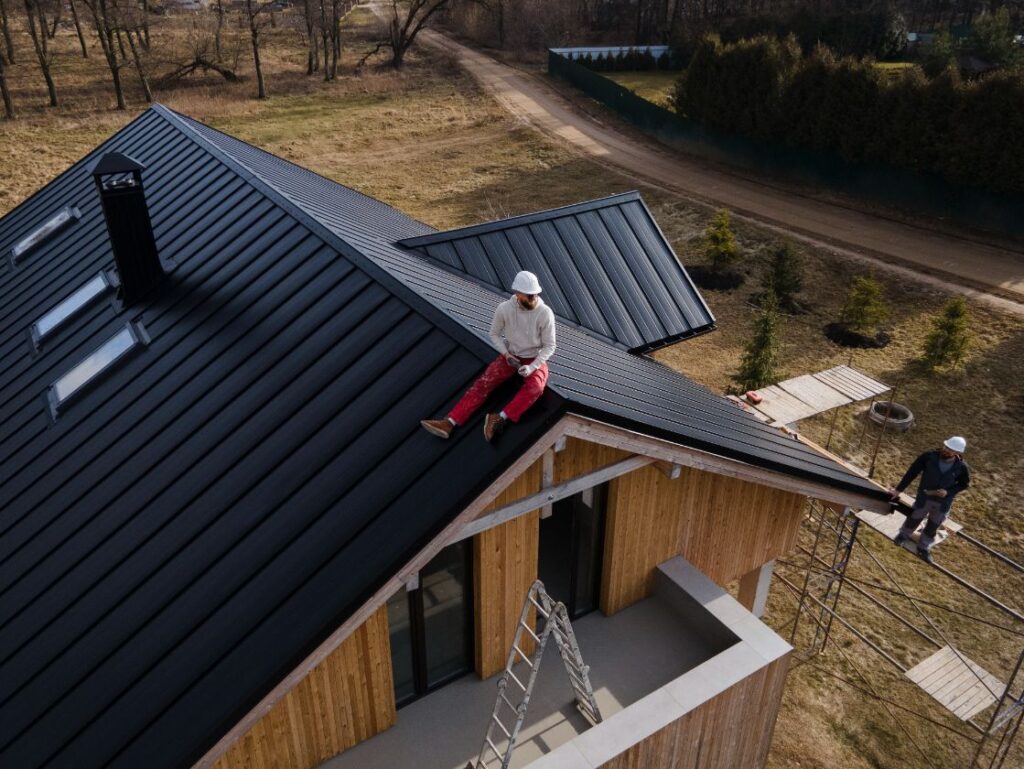 Man with helmet sitting on the roof