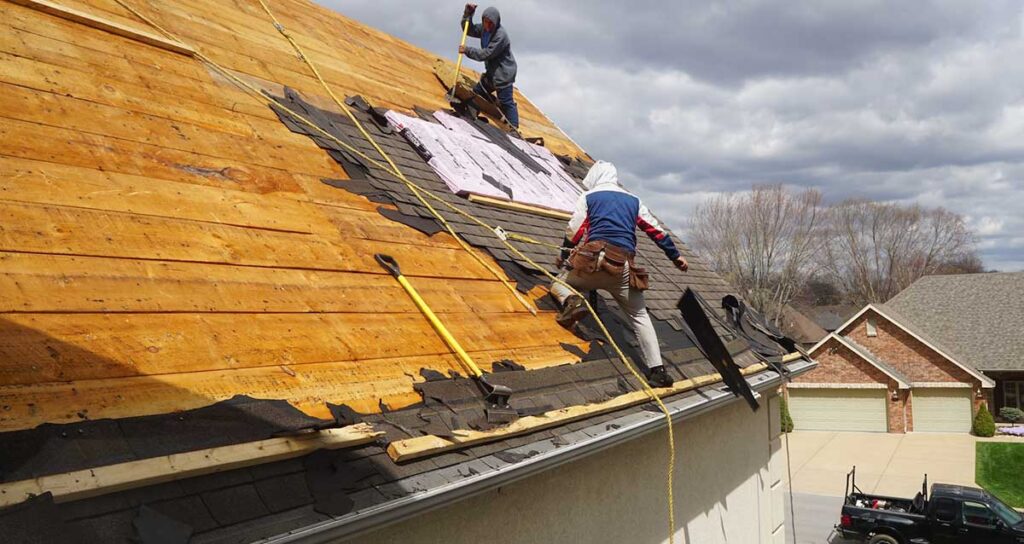 Professional roofers repairing and installing new roofs